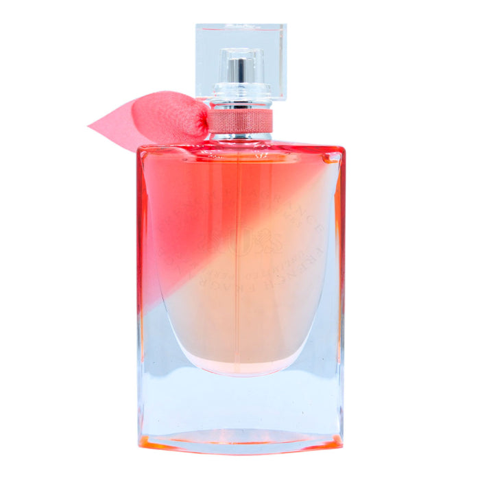 a bottle of perfume with a pink bow on top of it